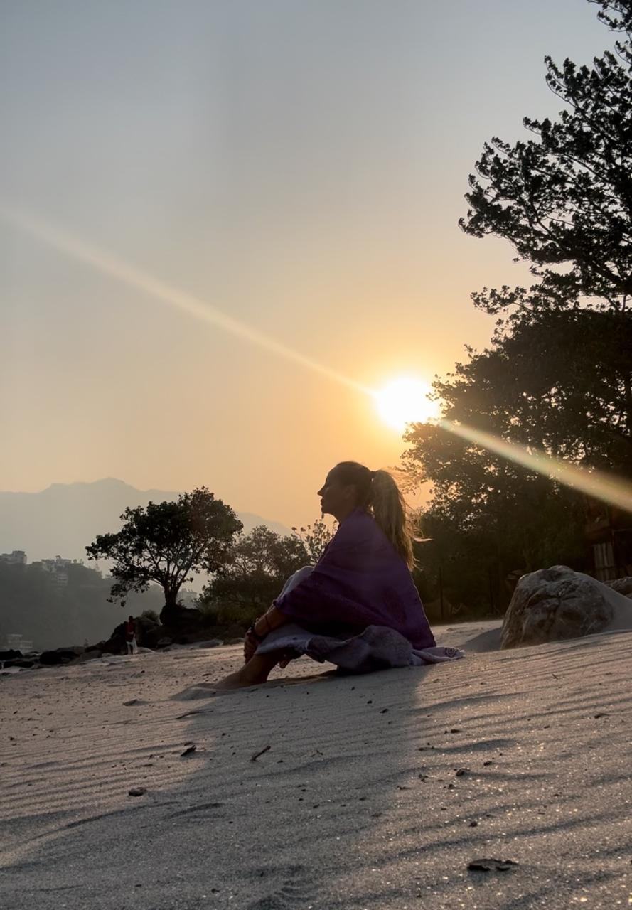Carly Cole seated in meditation at sunrise in the Himalayas